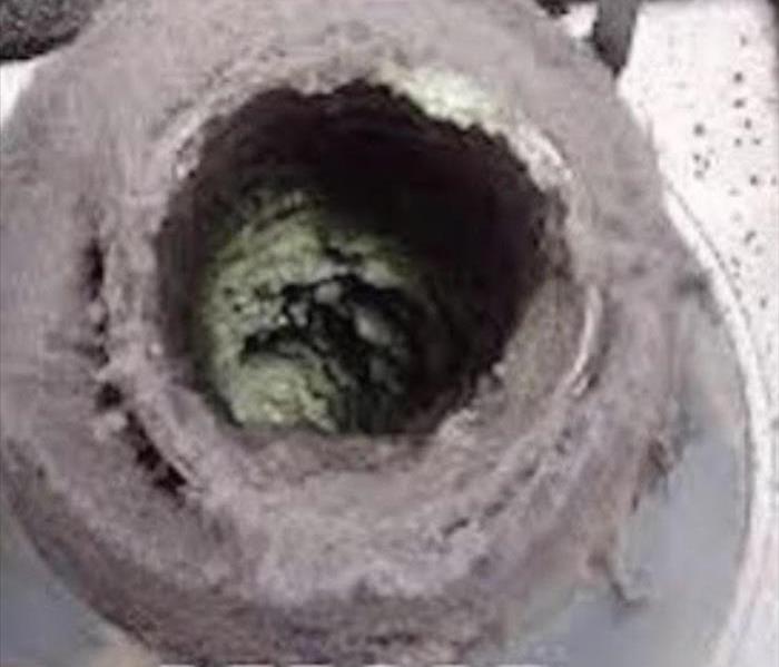 Lint buildup before cleaning the dryer vent.